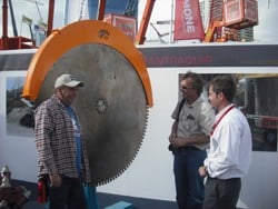 Visitor discussing Echidna diamond rock saw at Antraquip stand at ConExpo 2011 in Las Vegas